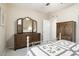 Bedroom with a white metal frame bed and large wooden dresser at 17009 W Eureka Springs Dr, Surprise, AZ 85387
