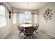 Charming dining area with round table, decorative lighting, and a bay window at 17009 W Eureka Springs Dr, Surprise, AZ 85387