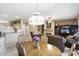 Open-concept dining area flowing into the living room with pendant lighting fixture at 17009 W Eureka Springs Dr, Surprise, AZ 85387