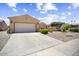 Charming single-story home featuring a spacious driveway, desert landscaping, and a two car garage at 17009 W Eureka Springs Dr, Surprise, AZ 85387