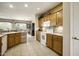Well-equipped kitchen with wood cabinets, white appliances, and tile backsplash at 17009 W Eureka Springs Dr, Surprise, AZ 85387