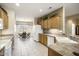 Bright kitchen with tile flooring, light wood cabinets, and a dining area at 17009 W Eureka Springs Dr, Surprise, AZ 85387