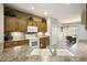 Cozy kitchen featuring light wood cabinets, mosaic backsplash, and white appliances at 17009 W Eureka Springs Dr, Surprise, AZ 85387