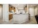 Open-concept kitchen with breakfast bar, tile floors, and light wood cabinetry at 17009 W Eureka Springs Dr, Surprise, AZ 85387