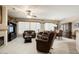 Spacious living room with plush carpeting, fireplace, and plenty of seating at 17009 W Eureka Springs Dr, Surprise, AZ 85387