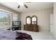 Spacious main bedroom with a ceiling fan, large window, and a stylish dresser at 17009 W Eureka Springs Dr, Surprise, AZ 85387