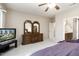 Serene main bedroom featuring neutral tones, a dresser with mirrors, and a TV at 17009 W Eureka Springs Dr, Surprise, AZ 85387