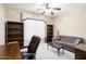 Office space with built in bookshelves, desk, and a sofa for relaxing at 17009 W Eureka Springs Dr, Surprise, AZ 85387