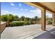 Covered patio overlooking a beautifully landscaped backyard with lush greenery at 17009 W Eureka Springs Dr, Surprise, AZ 85387