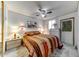 Comfortable bedroom featuring a ceiling fan, an attractive quilt, and a pair of bedside tables at 17200 W Bell Rd # 2162, Surprise, AZ 85374