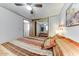 Inviting bedroom featuring a ceiling fan, mirror closet, and a comfortable bed with colorful bedding at 17200 W Bell Rd # 2162, Surprise, AZ 85374