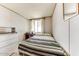 Modest bedroom featuring a simple bed, window with curtains, and dresser, providing a comfortable space at 17200 W Bell Rd # 2162, Surprise, AZ 85374