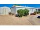 Charming home exterior with well-maintained landscaping and a separate storage shed at 17200 W Bell Rd # 2162, Surprise, AZ 85374