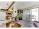 Bright living room with an electric fireplace and sliding doors to outdoor space at 17200 W Bell Rd # 2162, Surprise, AZ 85374