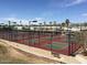 A view of the community's pickleball courts surrounded by lush landscaping and desert trees at 17200 W Bell Rd # 2162, Surprise, AZ 85374