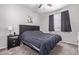 Bedroom featuring dark carpet, large window, and a queen sized bed at 17338 W Via De Luna Dr, Surprise, AZ 85387