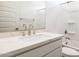 Bathroom boasts a white vanity and marble countertops with shower in the background at 17746 W Turquoise Ave, Waddell, AZ 85355