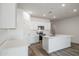 Bright, modern kitchen features stainless steel appliances, a large island, and sleek white cabinetry at 17746 W Turquoise Ave, Waddell, AZ 85355