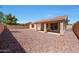This backyard features a covered patio and a rock landscape at 17910 N 92Nd Ln, Peoria, AZ 85382