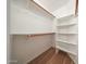 Functional walk-in closet with built-in shelving and rods for optimal storage and organization at 17910 N 92Nd Ln, Peoria, AZ 85382