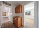 Hallway with a built-in cabinet and carpet flooring leads to a bedroom with natural light at 17910 N 92Nd Ln, Peoria, AZ 85382