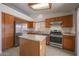 Well-equipped kitchen with stainless steel appliances, ample wood cabinetry, and a central kitchen island at 17910 N 92Nd Ln, Peoria, AZ 85382