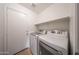 This laundry room features modern washer and dryer units at 17910 N 92Nd Ln, Peoria, AZ 85382