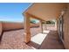 This covered patio features a rock yard and privacy walls at 17910 N 92Nd Ln, Peoria, AZ 85382