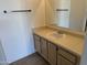 Bathroom featuring a clean countertop, sink, wood cabinetry, and a large mirror at 1825 W Ray Rd # 1008, Chandler, AZ 85224