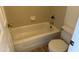 Classic white tiled bathroom featuring a standard bathtub and toilet with neutral flooring at 1825 W Ray Rd # 1008, Chandler, AZ 85224