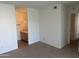 Neutral carpeted bedroom featuring an attached bathroom with wood vanity and white walls at 1825 W Ray Rd # 1008, Chandler, AZ 85224
