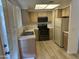 Bright kitchen with wood cabinets and appliances in neutral colors at 1825 W Ray Rd # 1008, Chandler, AZ 85224