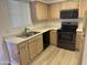 Cozy kitchen featuring stainless steel appliances, wood cabinets, and double basin sink at 1825 W Ray Rd # 1008, Chandler, AZ 85224