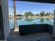 Serene lake view from a covered patio, palm trees, and a clear blue sky at 1825 W Ray Rd # 1008, Chandler, AZ 85224