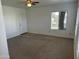 Cozy living room with neutral carpet, fan, and natural light from two windows at 1825 W Ray Rd # 1008, Chandler, AZ 85224