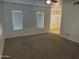 Spacious living room with neutral carpet and view to dining area through the opening at 1825 W Ray Rd # 1008, Chandler, AZ 85224