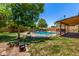 Relaxing fenced backyard features a refreshing pool, mature trees, and covered patio, perfect for outdoor enjoyment at 19206 N 40Th St, Phoenix, AZ 85050