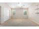 Bright bedroom with two windows, shelving, neutral carpet, and a spacious closet to maximize storage at 19206 N 40Th St, Phoenix, AZ 85050