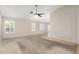 Bright living room with a ceiling fan, carpet flooring, and multiple windows offering ample natural light at 19206 N 40Th St, Phoenix, AZ 85050