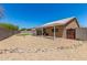 Expansive backyard featuring gravel, patio area with awning, and block wall fence at 2018 N 104Th Dr, Avondale, AZ 85392