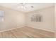 A bright bedroom featuring modern flooring and a ceiling fan at 2018 N 104Th Dr, Avondale, AZ 85392