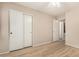 A bedroom featuring a ceiling fan, wood-style floors, and sliding closet doors at 2018 N 104Th Dr, Avondale, AZ 85392