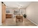 Bright dining room features modern flooring, ceiling fan, and backyard access at 2018 N 104Th Dr, Avondale, AZ 85392