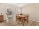 Dining area with wood table, chairs, and sliding glass door to the backyard at 2018 N 104Th Dr, Avondale, AZ 85392