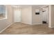 Inviting entryway with wood-look flooring, natural light, and neutral wall color at 2018 N 104Th Dr, Avondale, AZ 85392