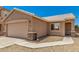 Exterior view of home with a two-car garage and desert landscaping at 2018 N 104Th Dr, Avondale, AZ 85392