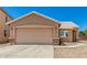 Home exterior featuring a two-car garage, gravel landscaping, and a tiled roof at 2018 N 104Th Dr, Avondale, AZ 85392