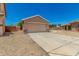 Charming single-story home featuring an attached two-car garage and low maintenance desert landscaping at 2018 N 104Th Dr, Avondale, AZ 85392