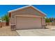 The exterior features a two-car garage with stone accents, a desert landscaped yard and a tile roof at 2018 N 104Th Dr, Avondale, AZ 85392