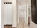 Hallway leading to bedroom and bathroom with wood-style and tile flooring at 2018 N 104Th Dr, Avondale, AZ 85392